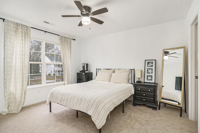 bedroom featuring light colored carpet and ceiling fan