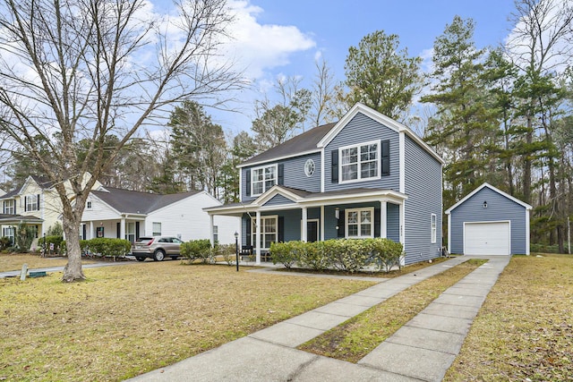 view of front of house featuring an outbuilding, a garage, covered porch, and a front yard