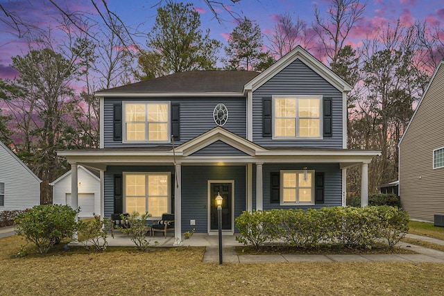 view of front of house with a porch and a garage