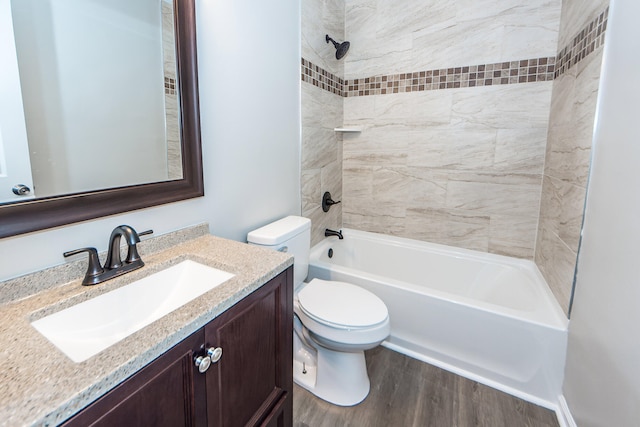 full bathroom with toilet, tiled shower / bath combo, vanity, and wood-type flooring