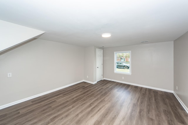 bonus room with dark hardwood / wood-style floors