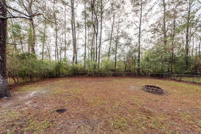 view of yard featuring an outdoor fire pit