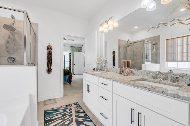 bathroom featuring an enclosed shower, vanity, tile patterned flooring, and a wealth of natural light