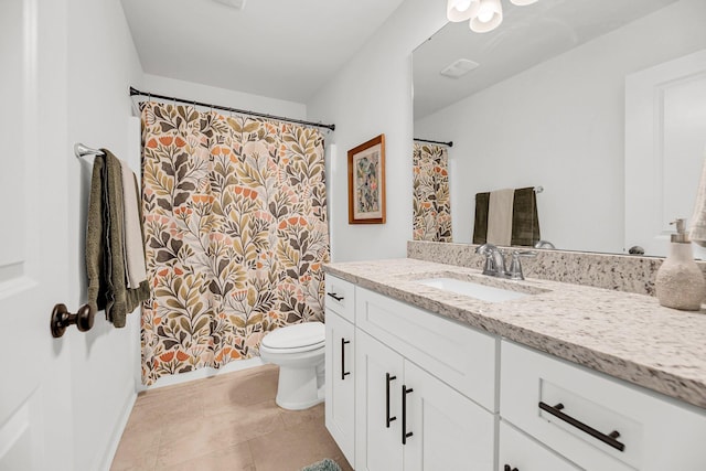 bathroom with vanity, tile patterned floors, and toilet