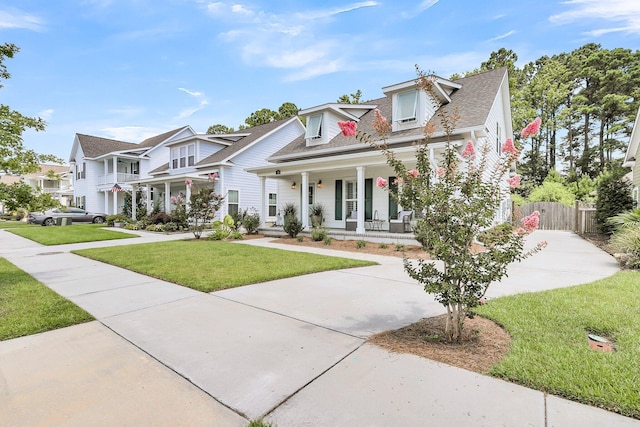 view of front of home featuring covered porch and a front yard