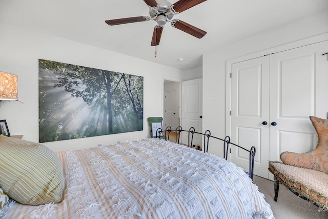 bedroom with light carpet, ceiling fan, and a closet