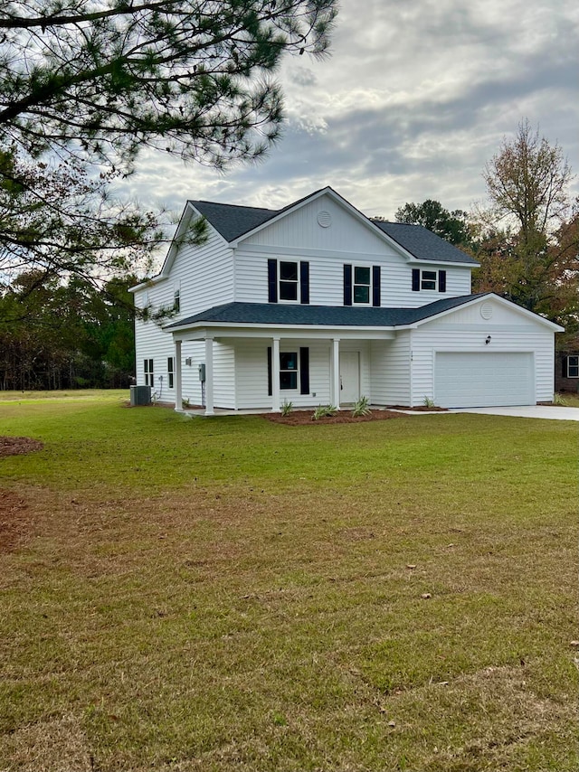 view of front of property with cooling unit, a front yard, and a garage