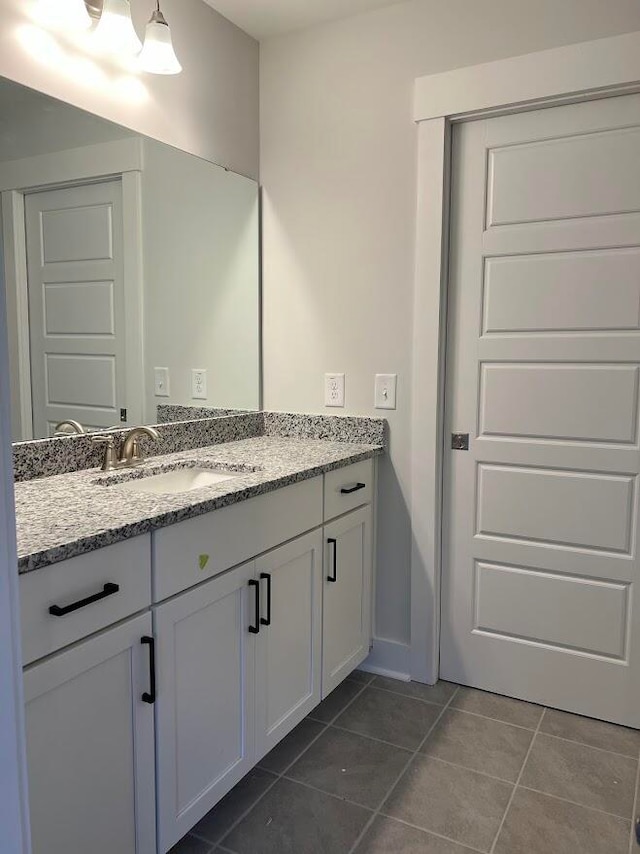 bathroom with tile patterned floors and vanity