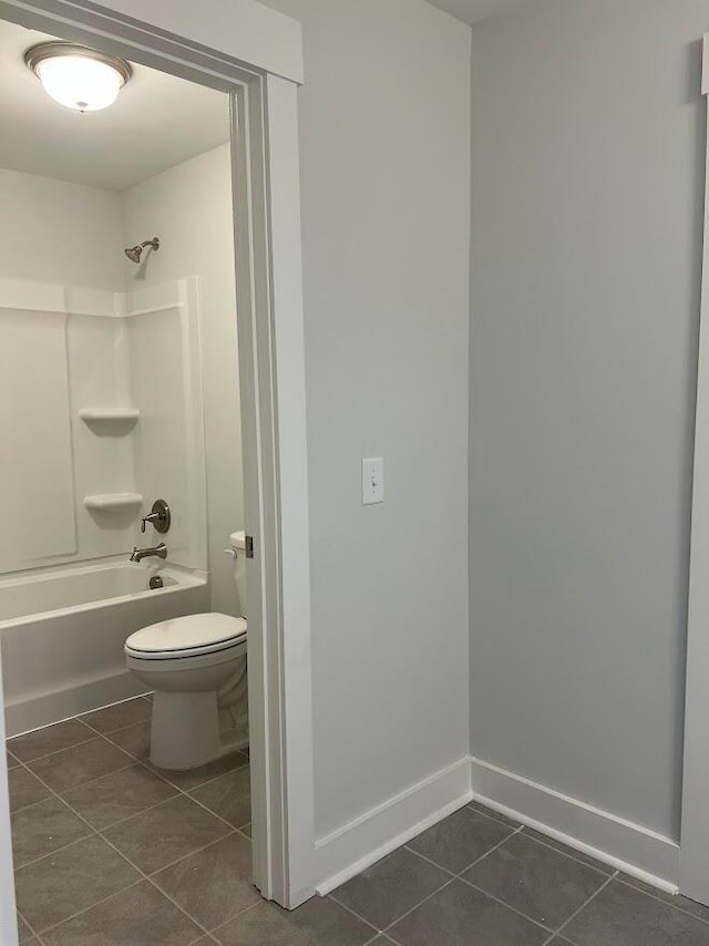 bathroom featuring tile patterned flooring, shower / bath combination, and toilet