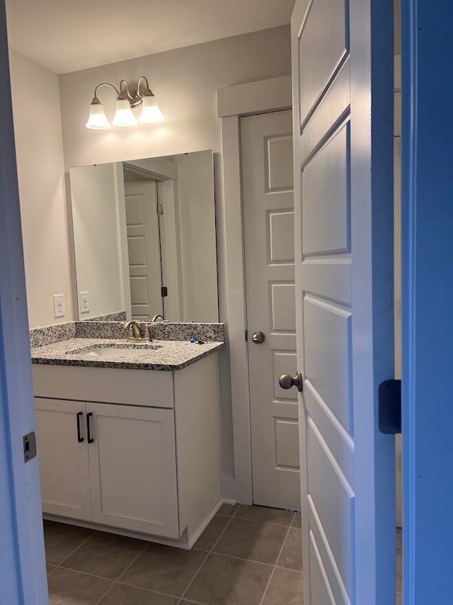 bathroom with tile patterned floors and vanity