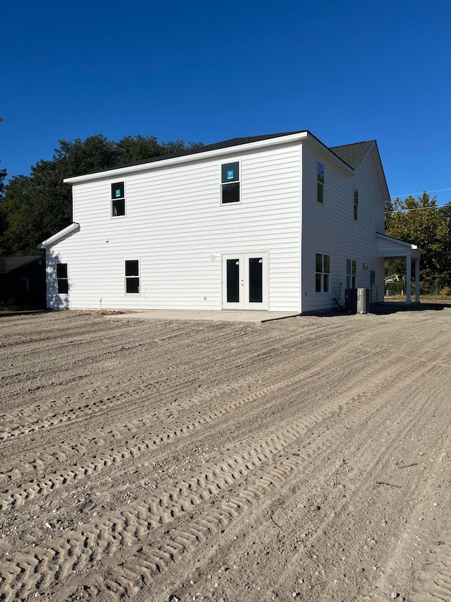 back of property with french doors and central AC unit