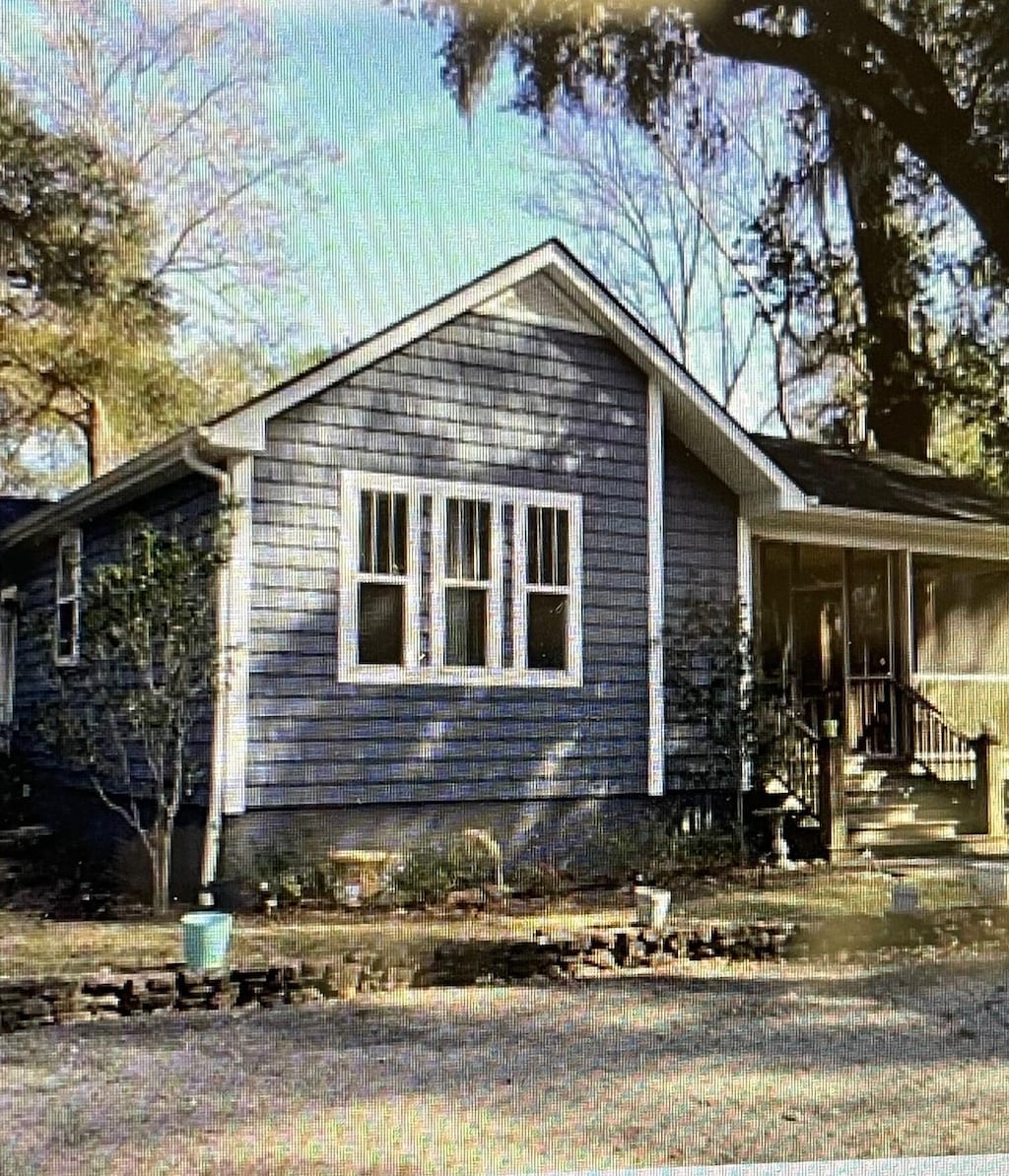 view of property exterior with a sunroom