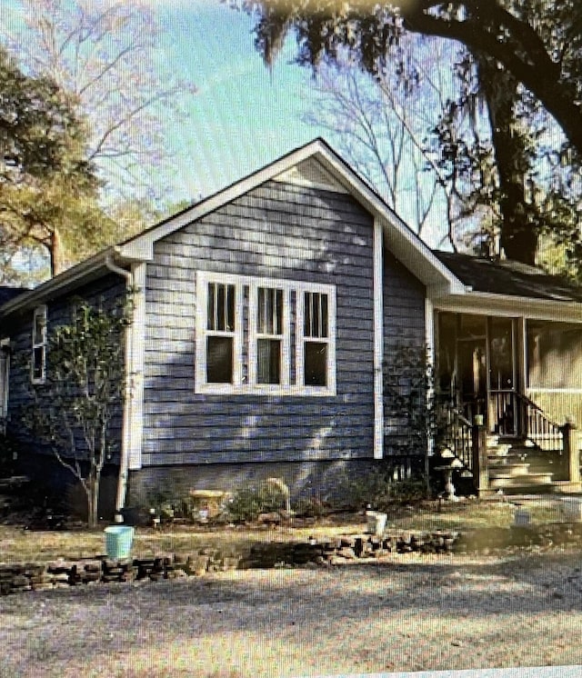 view of property exterior with a sunroom