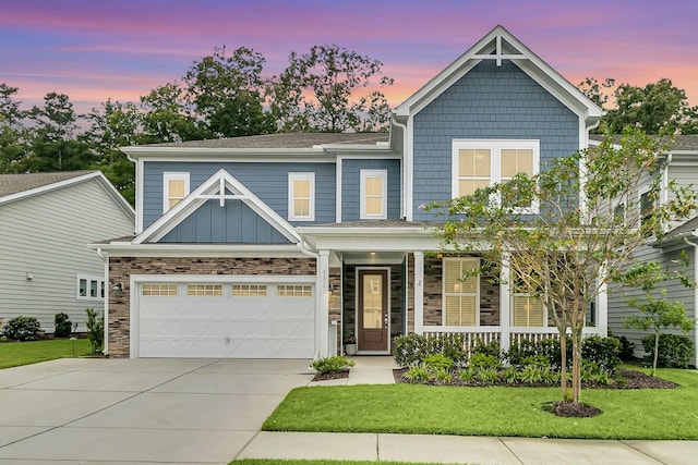 craftsman inspired home with a lawn and a garage