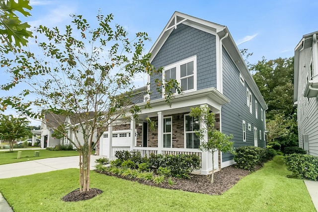 craftsman-style home with covered porch and a front lawn