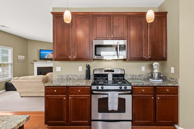 kitchen featuring light stone countertops, visible vents, and appliances with stainless steel finishes