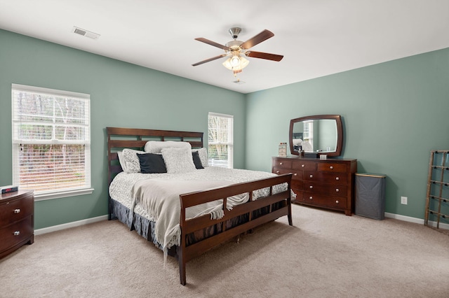 bedroom featuring visible vents, baseboards, carpet, and a ceiling fan