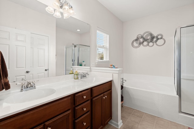 bathroom featuring a sink, a garden tub, double vanity, and a shower stall