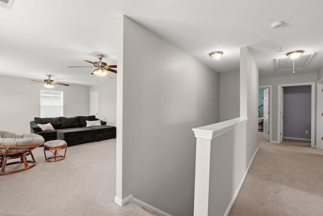 hall featuring baseboards, carpet floors, attic access, and an upstairs landing