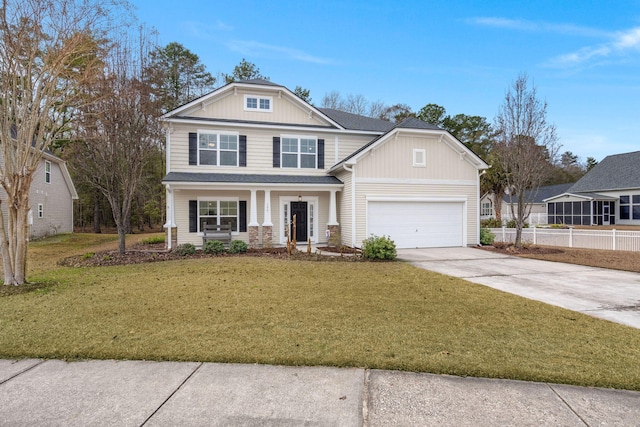 craftsman house with an attached garage, concrete driveway, a front yard, and fence