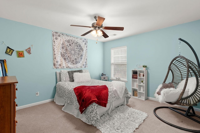 bedroom with baseboards, carpet floors, visible vents, and ceiling fan