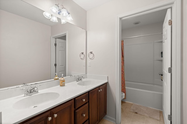 full bath featuring tile patterned flooring, double vanity, toilet, and a sink