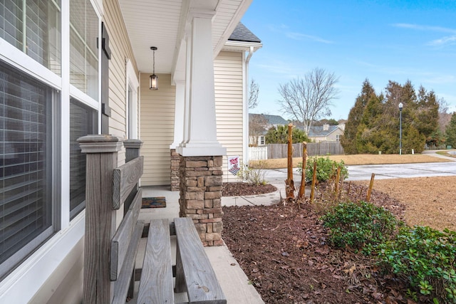 exterior space with fence and covered porch