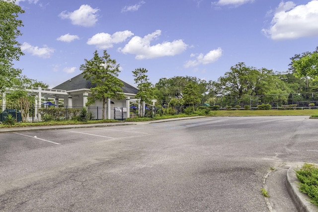 uncovered parking lot featuring fence