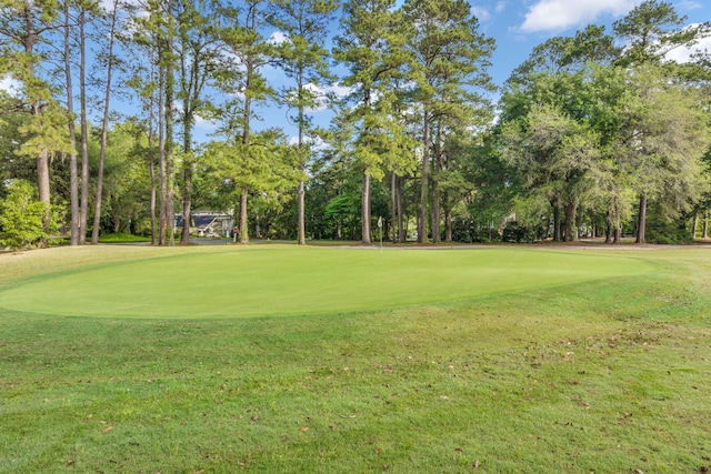 view of community featuring a lawn and golf course view