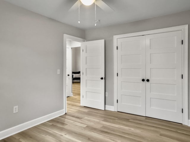 unfurnished bedroom with ceiling fan, a closet, and light hardwood / wood-style flooring