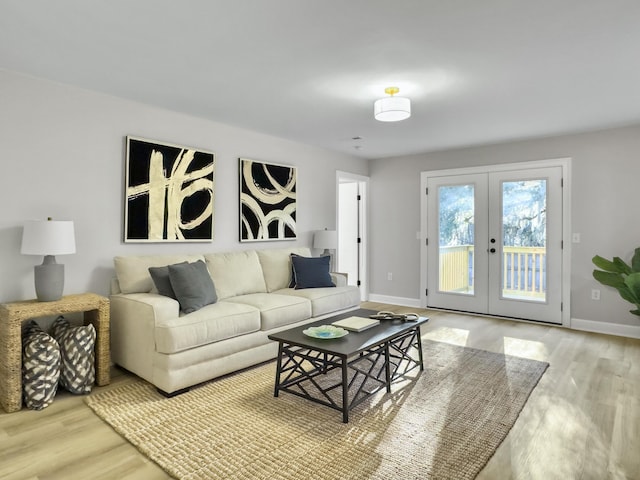 living room with light wood-type flooring and french doors