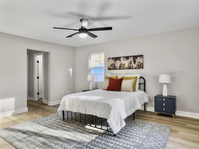 bedroom with light hardwood / wood-style floors and ceiling fan