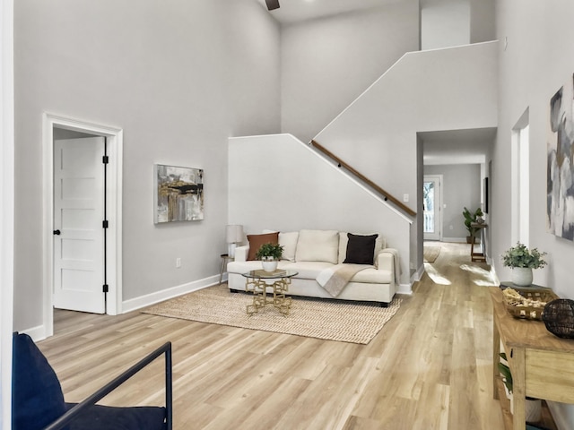 living room with hardwood / wood-style flooring and a high ceiling