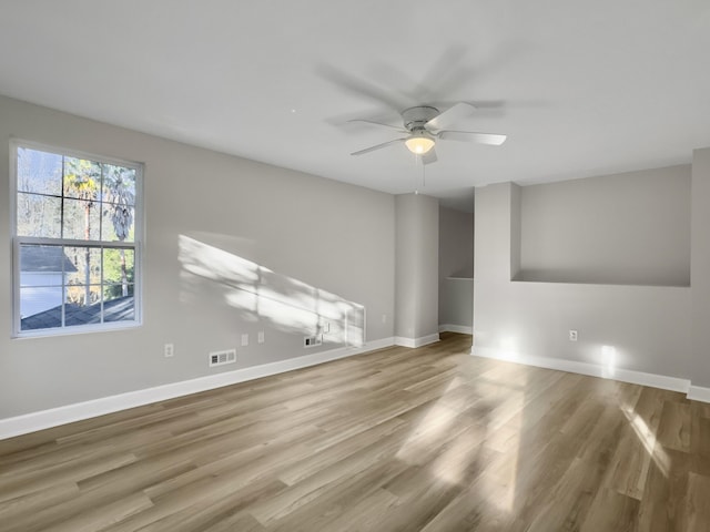 unfurnished living room with wood-type flooring and ceiling fan