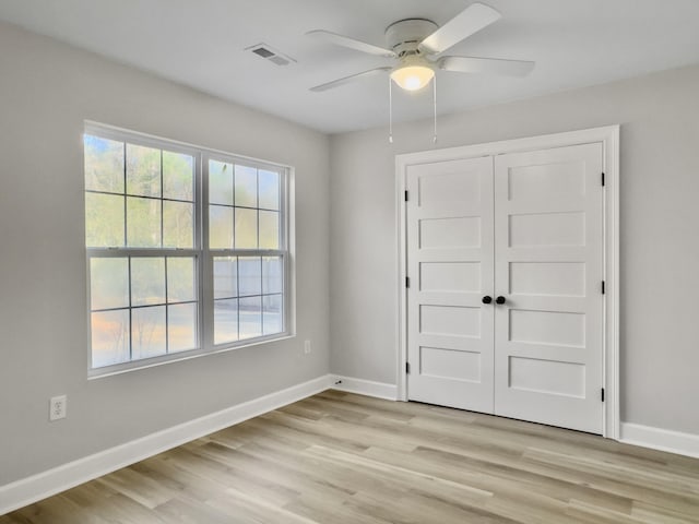 unfurnished bedroom with a closet, ceiling fan, and light wood-type flooring