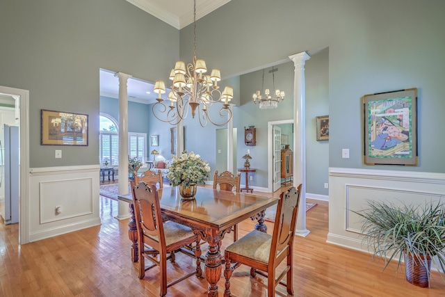 109 Waveney Cir, Goose Creek, SC 29445 - dining room featuring a high ceiling, crown molding, a chandelier, light wood finished floors, and wainscoting