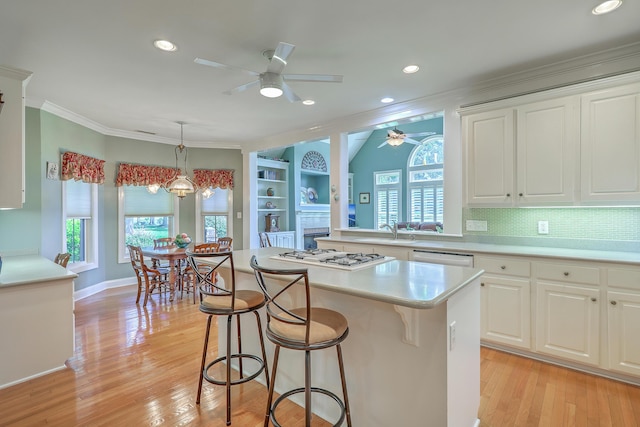 109 Waveney Cir, Goose Creek, SC 29445 - kitchen featuring ceiling fan, white appliances, a breakfast bar area, plenty of natural light, and ornamental molding