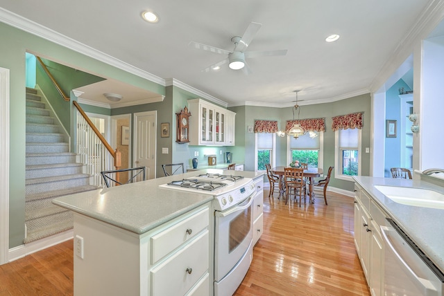109 Waveney Cir, Goose Creek, SC 29445 - kitchen featuring stainless steel dishwasher, white gas range, a ceiling fan, light countertops, and white cabinetry