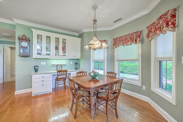 109 Waveney Cir, Goose Creek, SC 29445 - dining room with light wood-type flooring, ornamental molding, and a chandelier