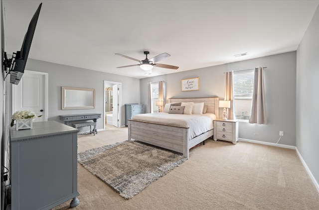 carpeted bedroom featuring ceiling fan and ensuite bathroom