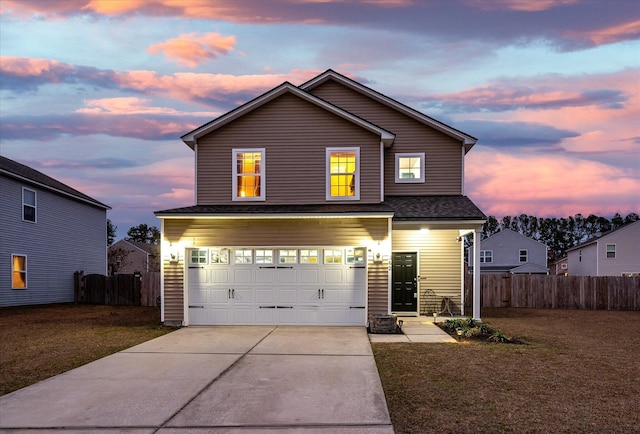 front facade with a garage and a lawn