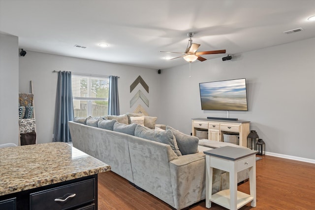 living room with ceiling fan and dark hardwood / wood-style flooring