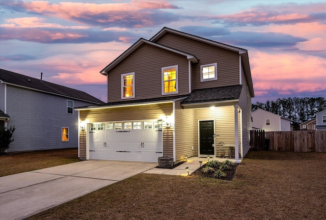 view of front of property featuring a garage and a lawn