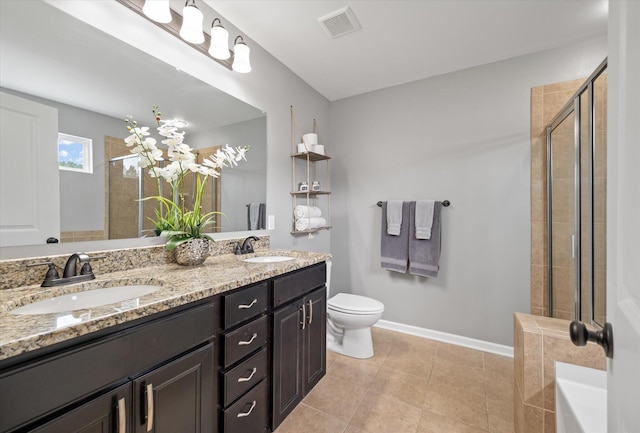 bathroom with tile patterned flooring, vanity, an enclosed shower, and toilet