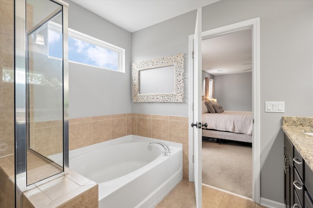 bathroom featuring tile patterned flooring, vanity, and a bathtub