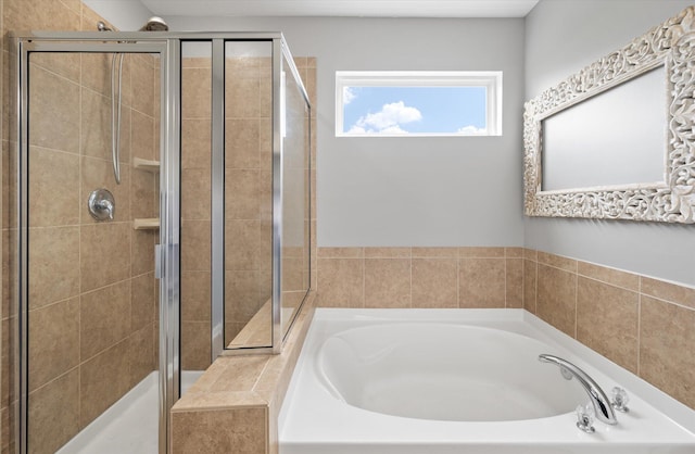 bathroom featuring shower with separate bathtub