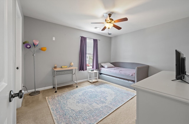 bedroom with ceiling fan and light carpet