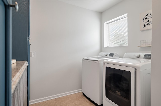 laundry room featuring light tile patterned floors and washer and clothes dryer