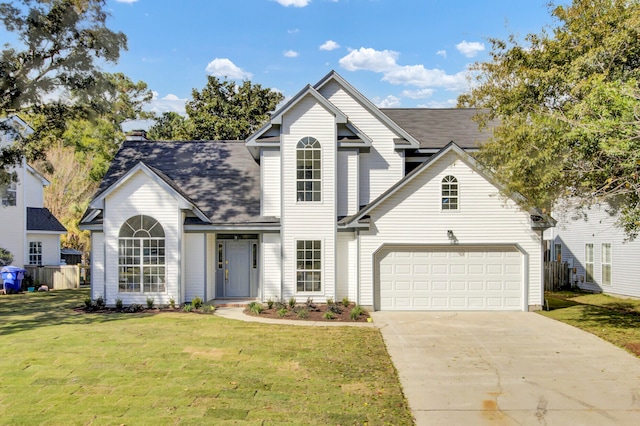 view of property featuring a front yard and a garage