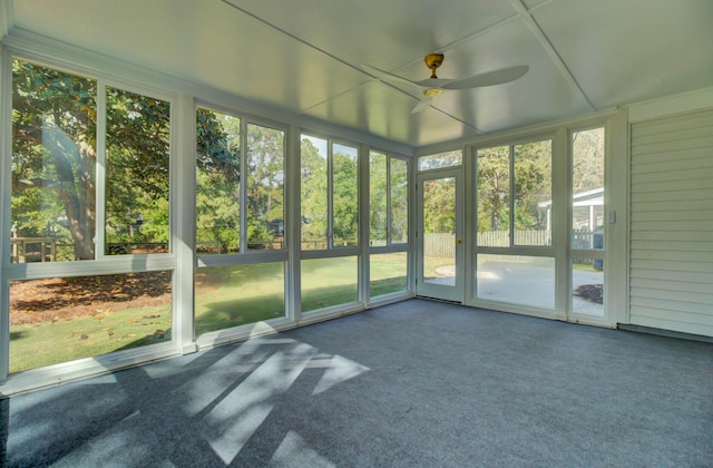 unfurnished sunroom with ceiling fan